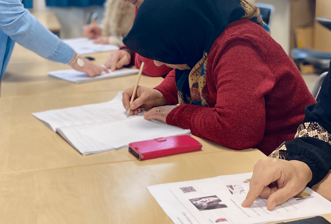 Sfi-elever skriver och läser.